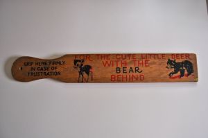 My maternal grandmother had this same paddle hanging on a nail on the wall, within arm's reach, behind her recliner.